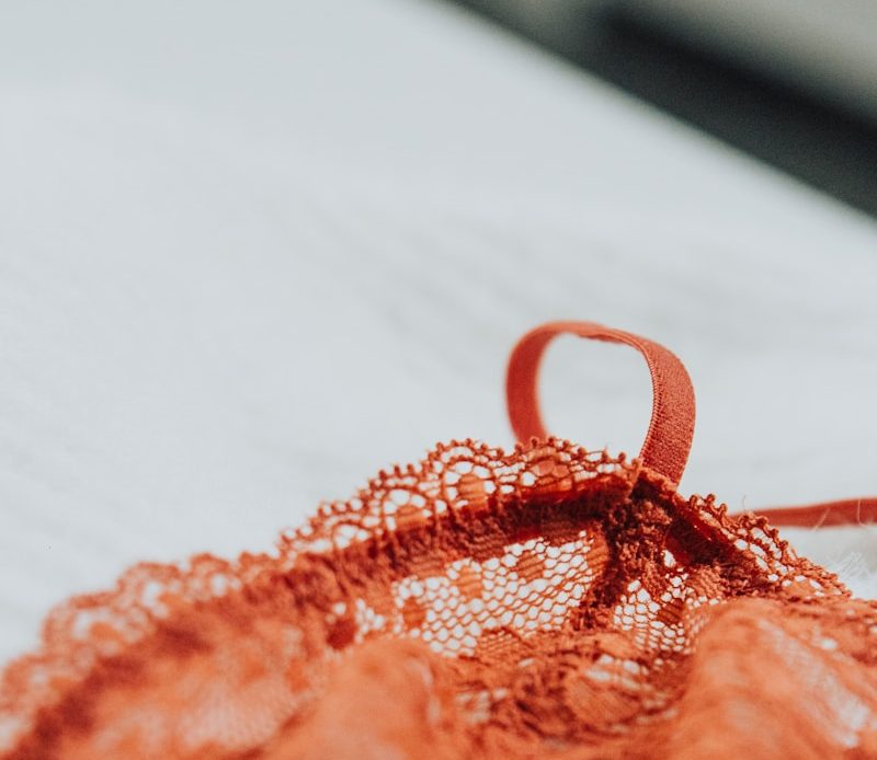 an orange piece of cloth with a knot on it