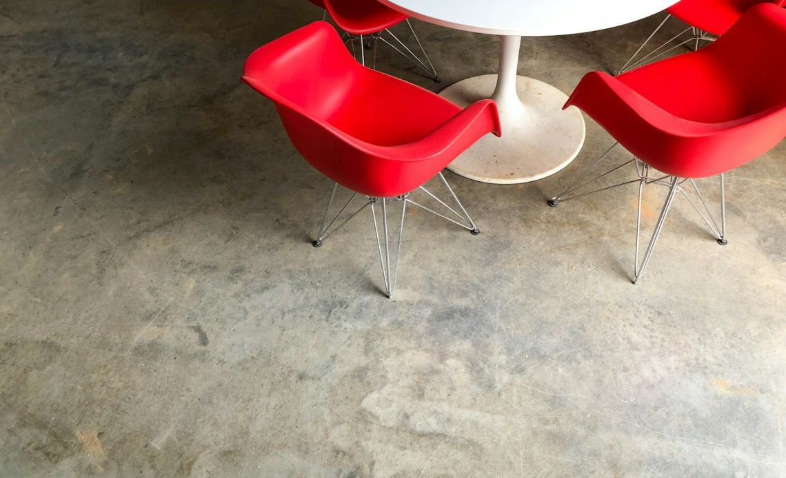 red plastic chairs near white pedestal table