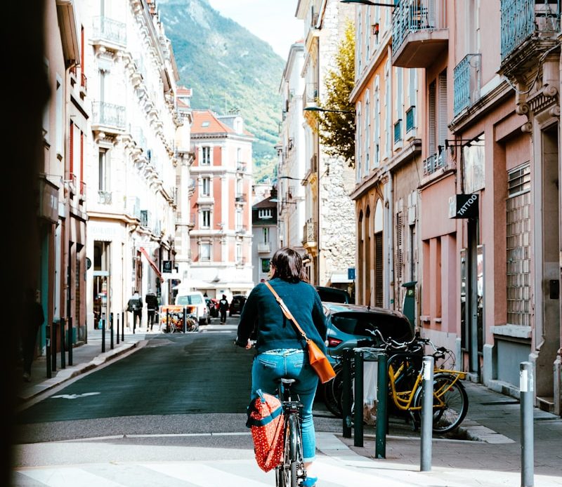 a person riding a bike down a street