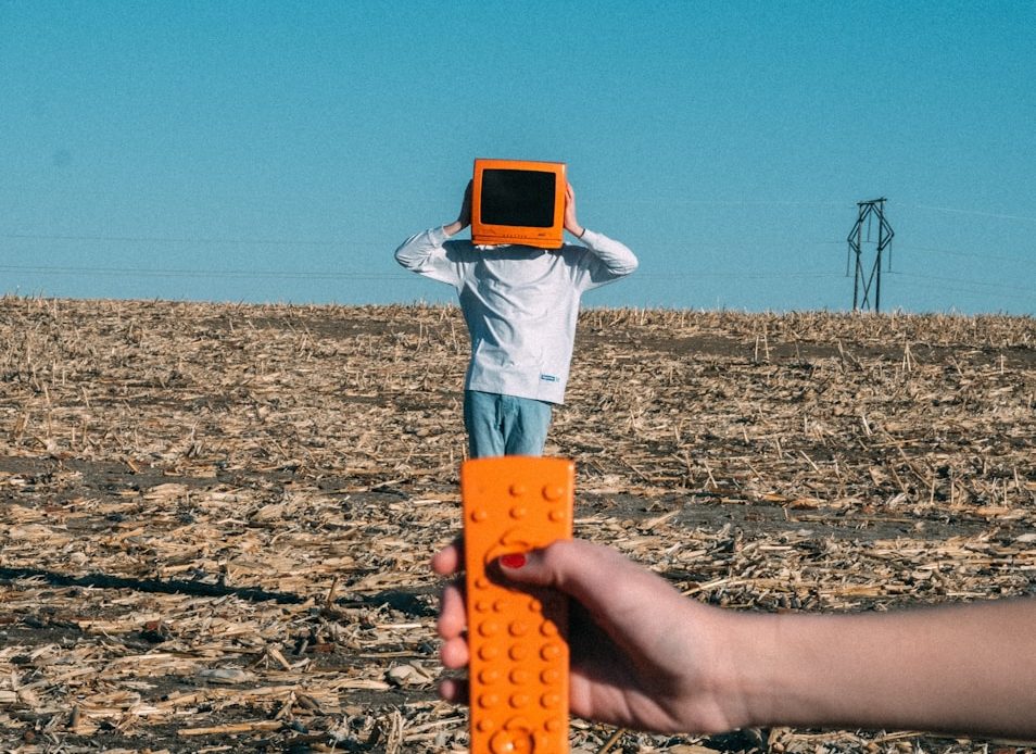 person wearing TV helmet with remote