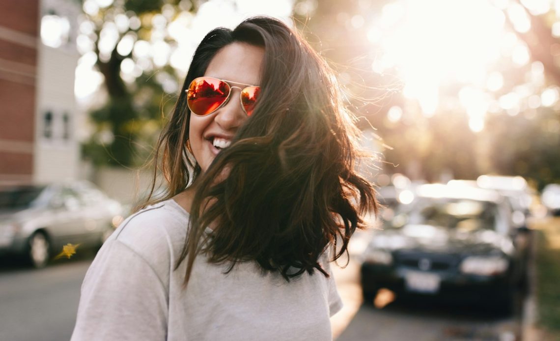 woman wearing white T-shirt smiling