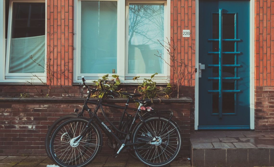 black road bicycles beside brown concrete wall during daytime