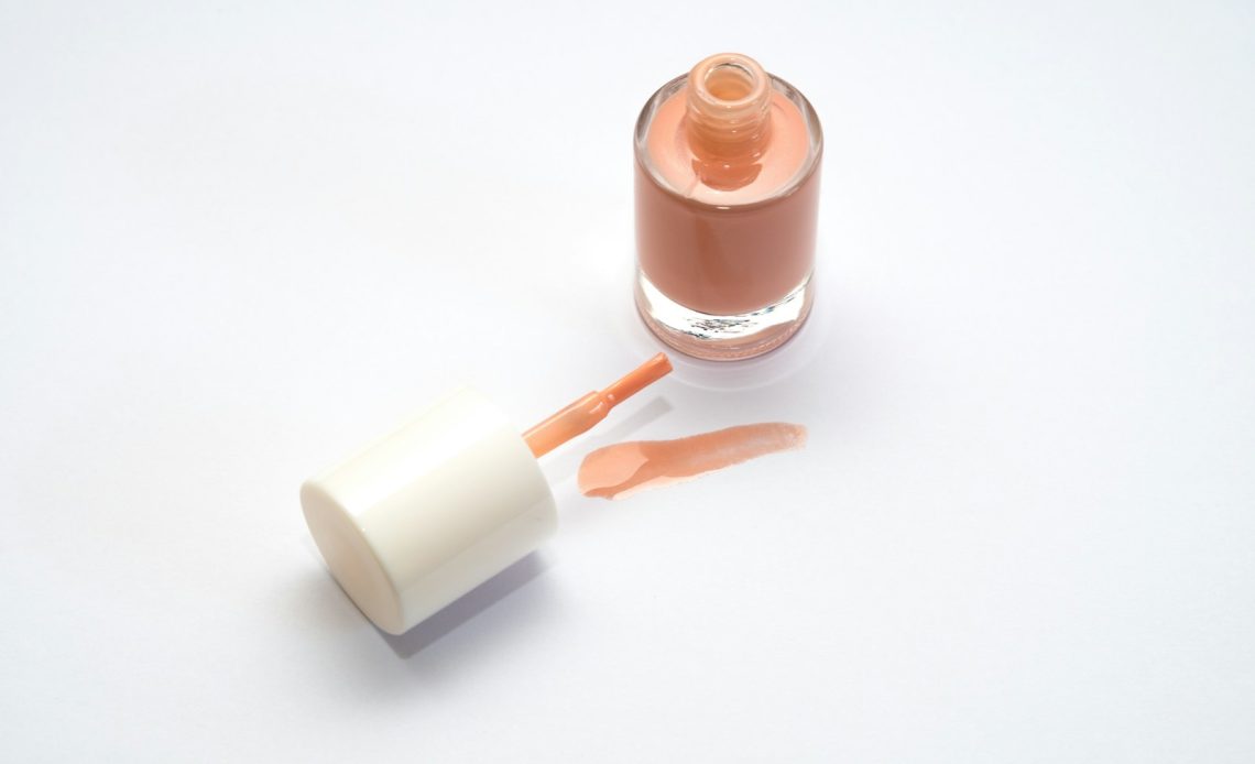 a bottle of liquid sitting next to a tube of liquid