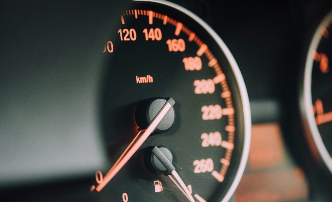 closeup photo of black analog speedometer